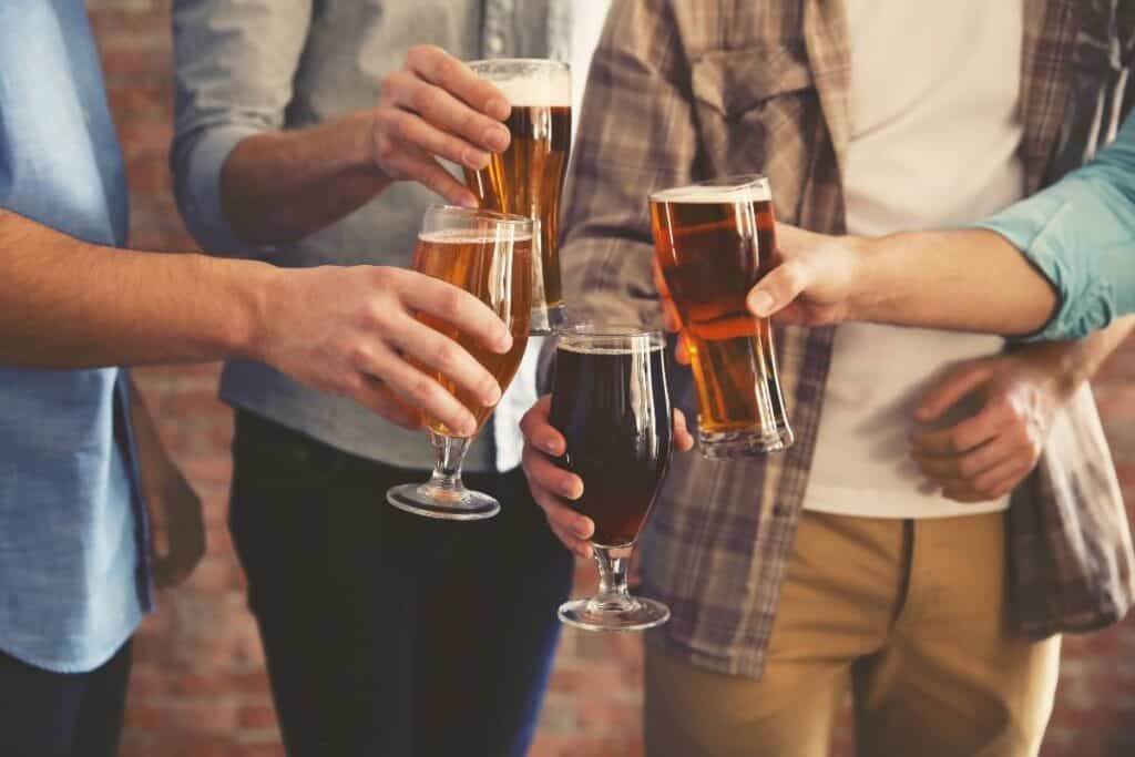 people holding glasses of michigan craft beers