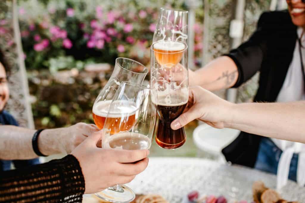 Friends clinking glasses of craft beer at a brewery in Traverse City, Michigan