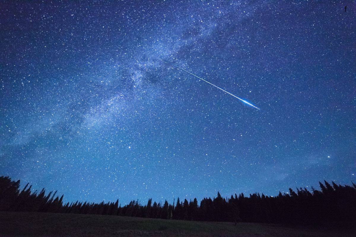meteors shooting across a dark sky 
