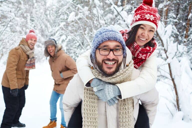 couples playing in the snow on a michigan winter getaway