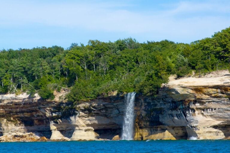 Waterfall spilling over the sandstone cliffs into Lake Superior at Pictured Rocks National Lakeshore in Michigan