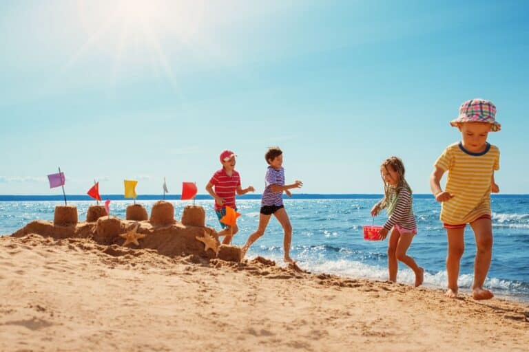 kids playing a beach during a michigan family vacation