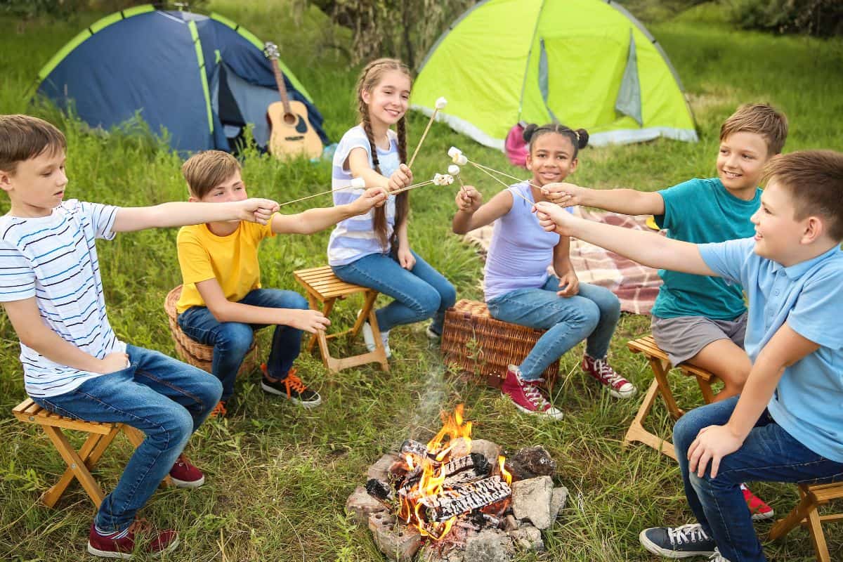 kids toasting marshmallows at a michigan summer camp