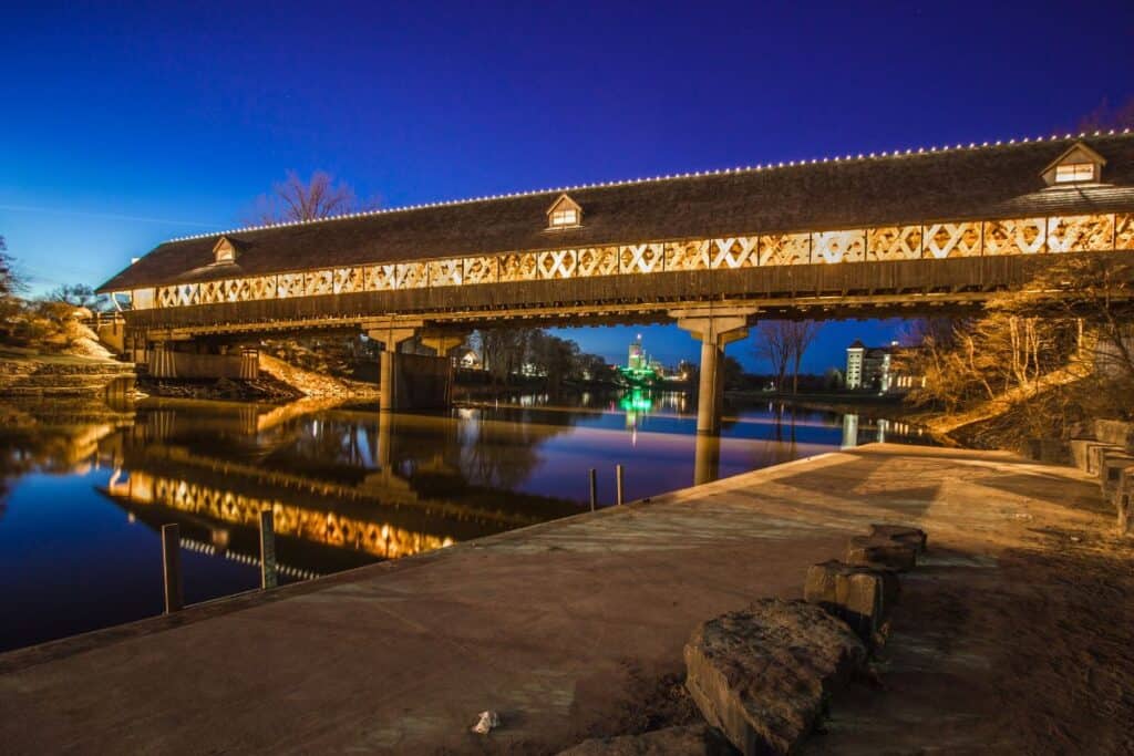 Holz-Brucke wooden covered bridge lit with Christmas lights over Cass River
