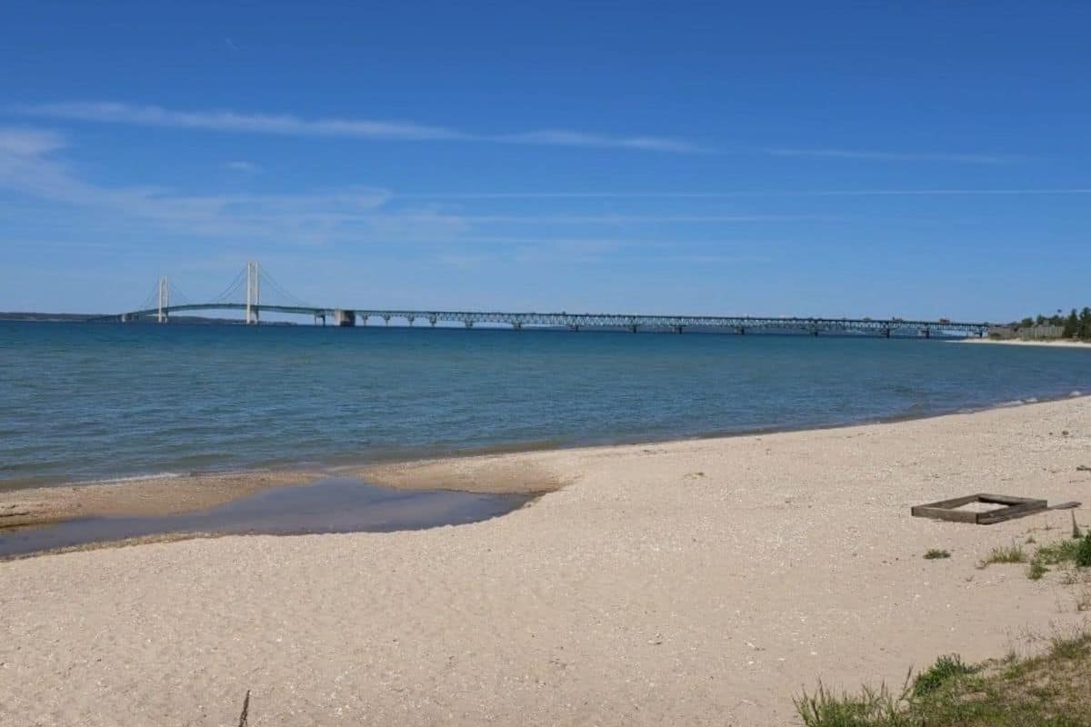 The Mackinac Bridge in the distance with beach in forefront