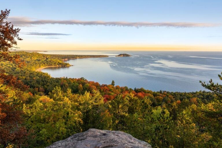 Little Presque Isle and the Lake Superior shoreline north of Marquette, Michigan, framed by red and orange fall trees
