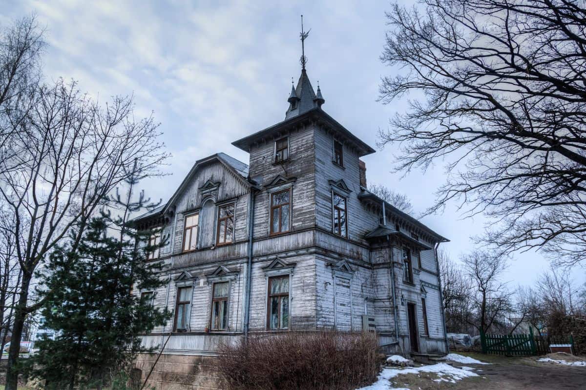 an old, haunted house in Michigan on a grey cloudy day