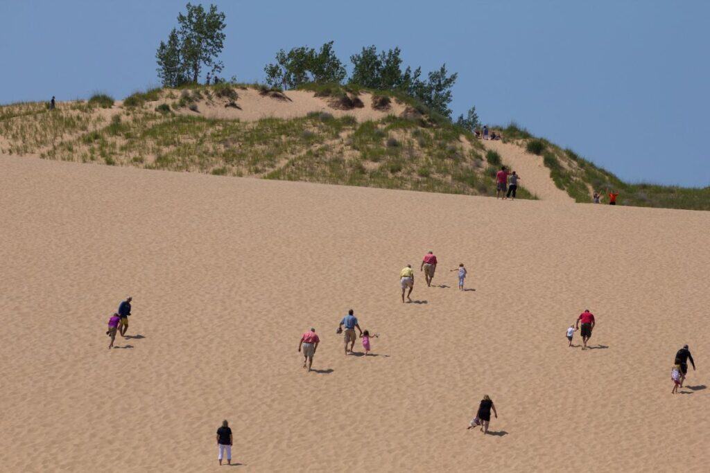 Visitors climbing the towering Dune at Sleeping Bear Dunes National Lakeshore