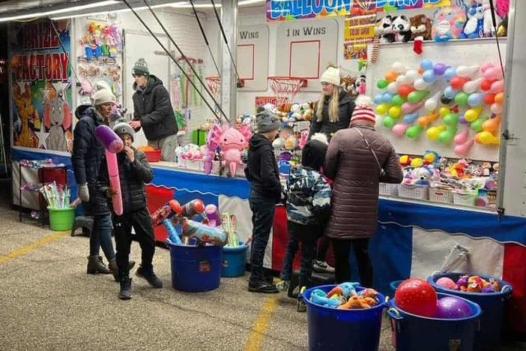 families playing games at the village of ashley country christmas 