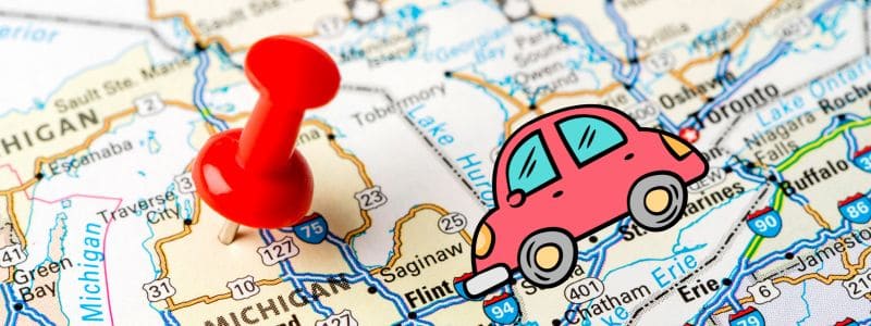 map of michigan with a pin stuck in it 