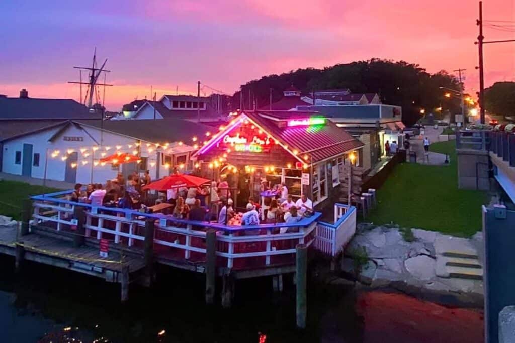 Captain Lou’s restaurant in South Haven Michigan with outdoor waterfront dining at sunset and colorful lights
