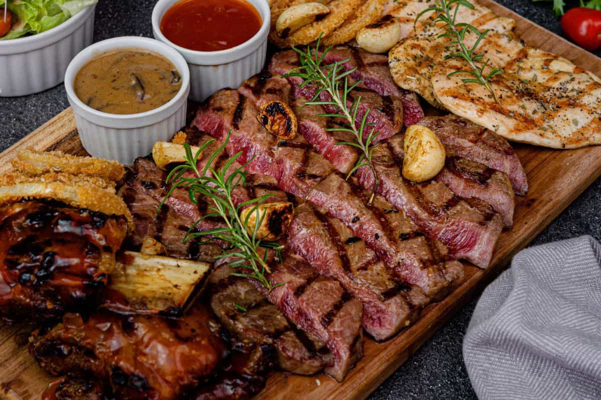 grilled steak and chicken platter with sauces at a restaurant in South Haven Michigan