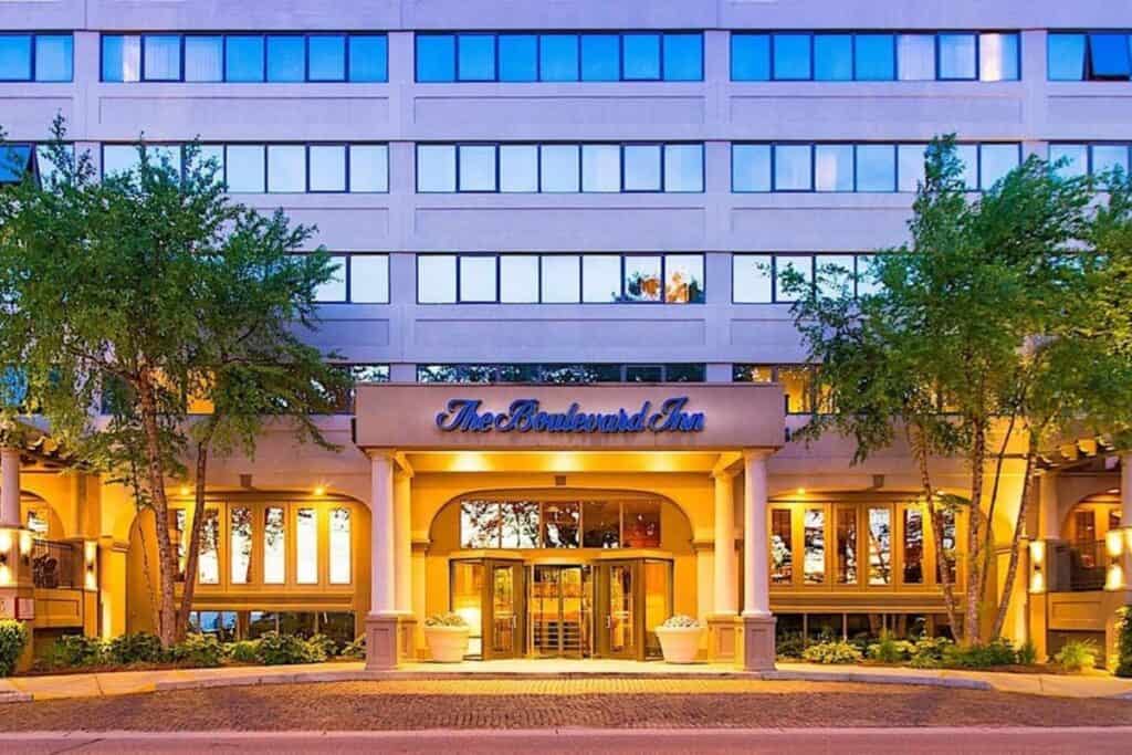 Lit entrance and columned portico of The Boulevard Inn & Bistro, an all-suite hotel in downtown St. Joseph Michigan