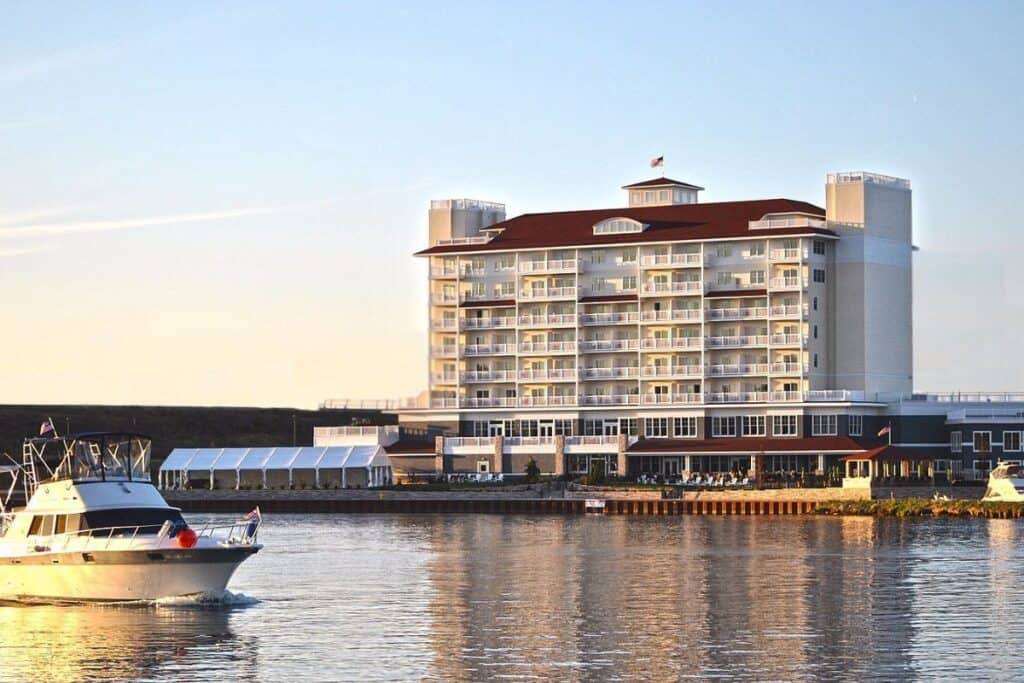 The Inn at Harbor Shores viewed from the St. Joseph River with a boat passing at sunset