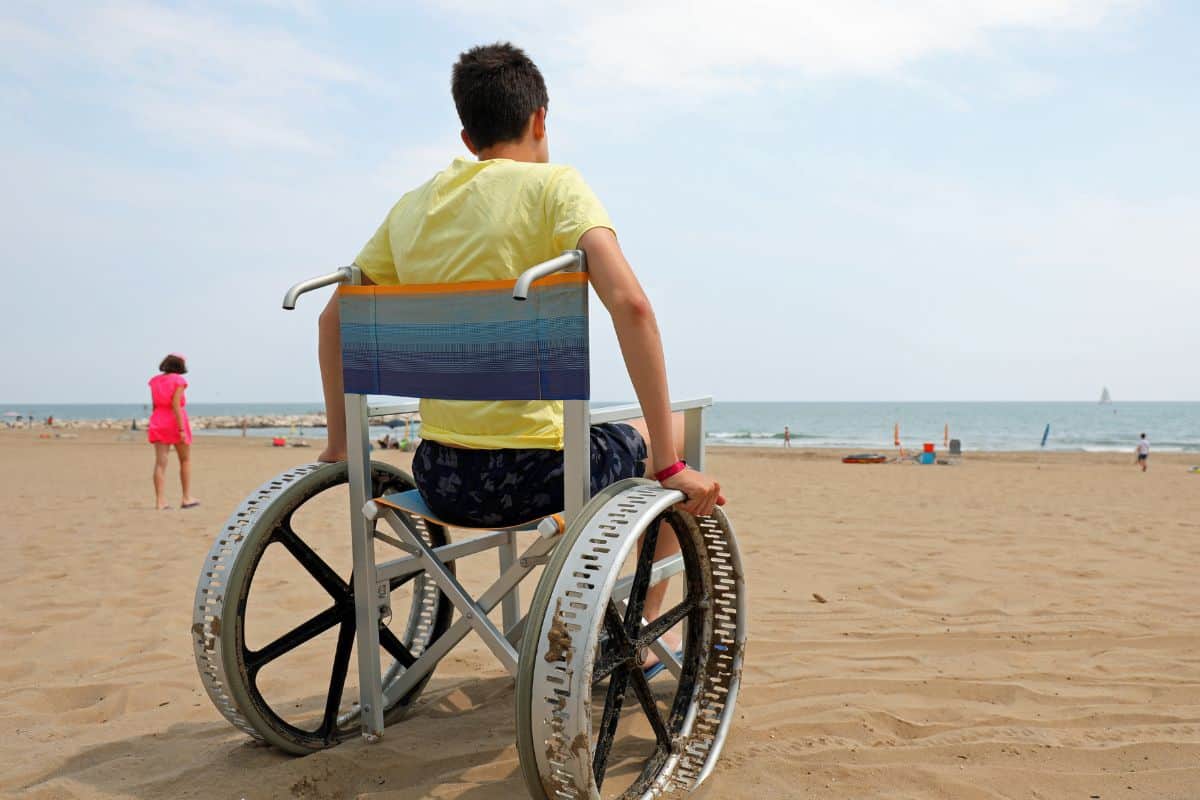 man in a beach wheelchair at an accessible Lake Huron beach in Michigan