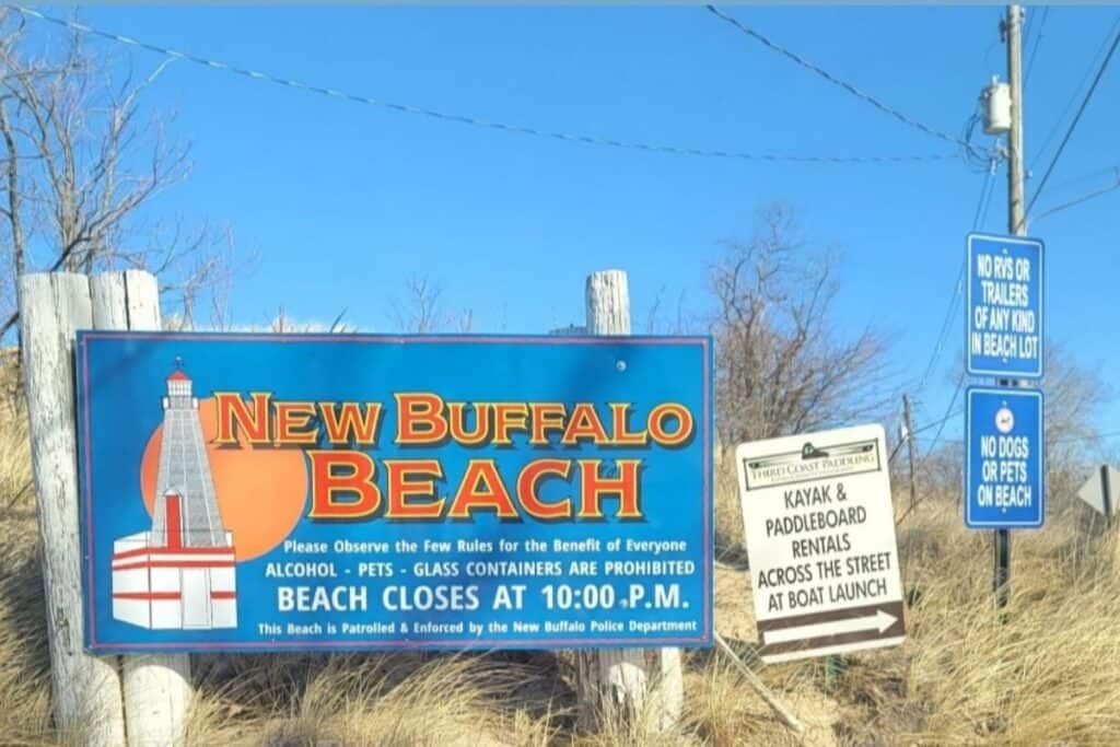 New Buffalo Beach sign showing rules including no alcohol, no pets, and beach closes at 10pm