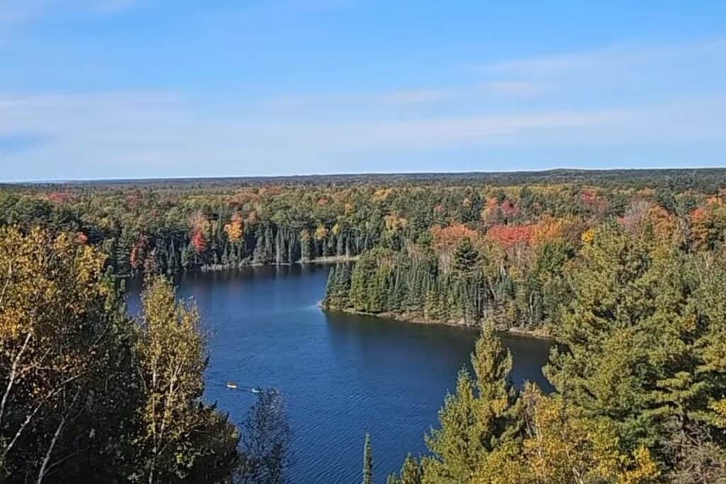  Peak fall color over Foote Dam Pond viewed from the overlook along the River Road National Scenic Byway near Oscoda Michigan