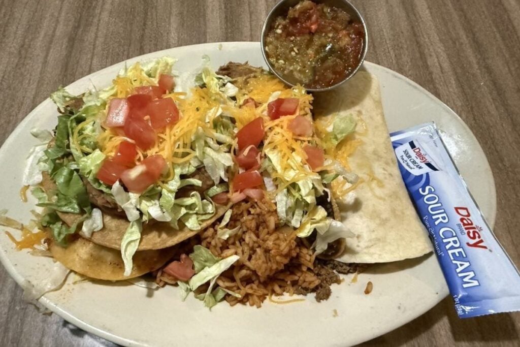 Mexican combo plate with tacos, Spanish rice, salsa, and a tortilla at Desi's Family Dining in Oscoda, Michigan