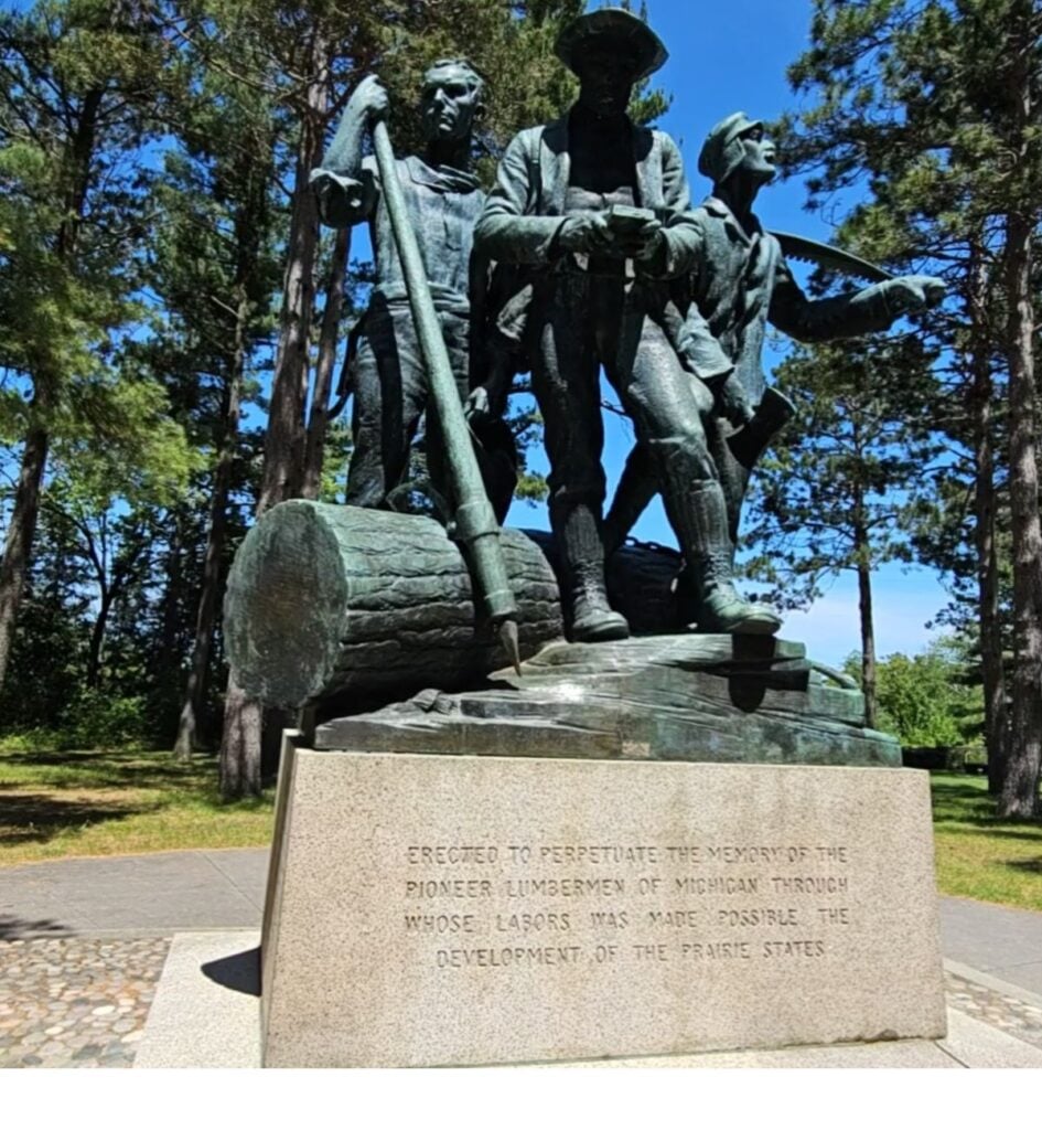 Lumberman's Monument bronze statue of three pioneer lumbermen above the Au Sable River in Oscoda, Michigan