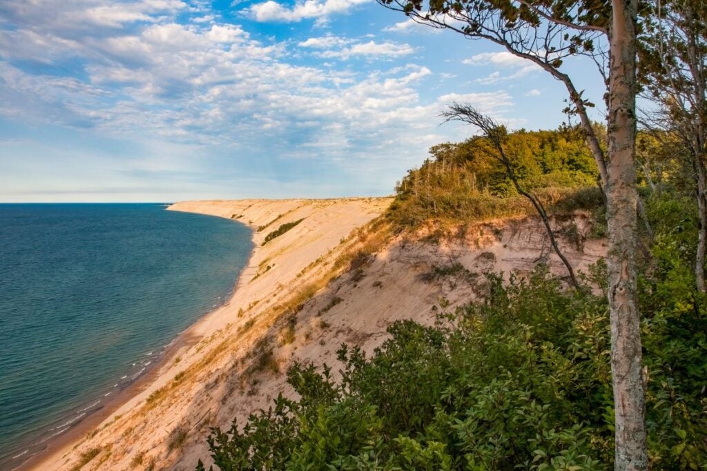 Late afternoon light on the Grand Sable Dunes and Lake Superior shoreline, seen from the wooded bluff near the Log Slide Overlook